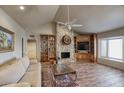Inviting living room with stone fireplace, built-in bookshelves, and a large window at 536 W Surrey Ave, Phoenix, AZ 85029