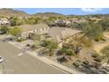 Aerial shot of a home, showcasing desert landscaping in a neighborhood with mountain views at 5721 W Molly Ln, Phoenix, AZ 85083