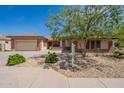 Charming single-story home featuring a well-manicured, xeriscaped yard and a two-car garage at 5721 W Molly Ln, Phoenix, AZ 85083