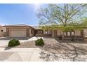 Beautiful home with a two-car garage and a quaint desert landscape at 5721 W Molly Ln, Phoenix, AZ 85083