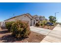 Wide angle view of a single-Gathering home in a residential neighborhood with desert landscaping at 5875 N 195Th Dr, Litchfield Park, AZ 85340