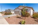 Attractive single-story home boasting a two-car garage, xeriscaping, and desert plants at 5875 N 195Th Dr, Litchfield Park, AZ 85340