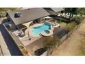 Backyard oasis with a sparkling pool, lush landscaping, and covered patio area for relaxing at 6522 S Farmer Ave, Tempe, AZ 85283