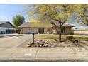 Beautiful single-story home with a well-manicured lawn, mature trees, and brick exterior at 6522 S Farmer Ave, Tempe, AZ 85283