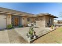 This home features a welcoming front patio, a brick facade, and a well-maintained lawn at 6522 S Farmer Ave, Tempe, AZ 85283