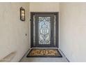 Close-up of the intricate wrought iron front door with a decorative welcome mat at 7745 E Calle De Las Brisas --, Scottsdale, AZ 85255