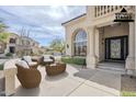 Inviting front porch with decorative columns and outdoor seating, perfect for relaxing at 7745 E Calle De Las Brisas --, Scottsdale, AZ 85255