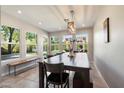 Bright dining room with a large wooden table, bench seating, and views of the landscaped backyard at 7800 E Via Del Futuro E --, Scottsdale, AZ 85258