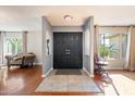 Inviting entryway featuring a modern black door, neutral walls, and warm hardwood floors at 7800 E Via Del Futuro E --, Scottsdale, AZ 85258