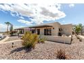 Desert-landscaped townhome featuring a private entryway and covered patio at 849 E Lancaster Cir, Florence, AZ 85132