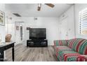 Bright living room with laminate flooring and a view to the entryway at 849 E Lancaster Cir, Florence, AZ 85132