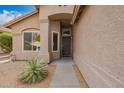 Inviting home entrance featuring a secure screen door, desert landscaping, and a well-maintained walkway at 8867 E Avenida Las Noches --, Gold Canyon, AZ 85118