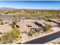 Aerial view of the property showcasing the house, landscaping, and golf course at 9560 E Preserve Way, Scottsdale, AZ 85262