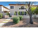 Charming two-story home with well-maintained landscaping, decorative wall, and mature shade trees at 10256 N 12Th Pl # 3, Phoenix, AZ 85020