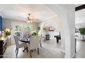 Charming dining room with a round table, arched doorway and a view into the living room at 10800 N 101St St, Scottsdale, AZ 85260