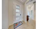 Modern front door with glass panels, tile flooring, and a colorful welcome mat in the entryway at 12008 S 186Th Dr, Goodyear, AZ 85338