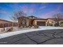 Charming single-story home with a well-manicured desert landscape and a two-car garage at 12008 S 186Th Dr, Goodyear, AZ 85338