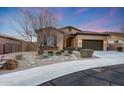 Charming single-story home with a well-manicured desert landscape and a two-car garage at 12008 S 186Th Dr, Goodyear, AZ 85338