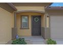 Inviting front entrance featuring a secure screen door and a lovely decorative wreath at 1257 N 166Th Ave, Goodyear, AZ 85338