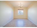 Bright and airy dining room featuring neutral paint and tile flooring, awaiting personalization at 16089 W Harvard St, Goodyear, AZ 85395