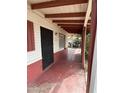 Inviting covered front porch featuring a secure front door with a gated door, and red painted concrete at 1616 E Pecan Rd, Phoenix, AZ 85040