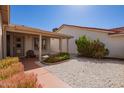 Cozy single-story house featuring a covered front porch and desert landscaping in a peaceful neighborhood at 1632 Leisure World --, Mesa, AZ 85206