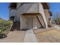 Inviting front door with unique design, complemented by warm lighting and well-maintained landscaping at 16402 N 31St St # 107, Phoenix, AZ 85032