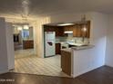 Bright kitchen featuring tiled floors, wood cabinetry, and a full appliance package at 16402 N 31St St # 117, Phoenix, AZ 85032