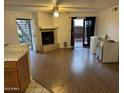 Cozy living room with a fireplace, wood floors, and sliding door access to an outdoor patio at 16402 N 31St St # 117, Phoenix, AZ 85032