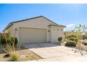 Charming single-story home showcasing a two-car garage, desert landscaping, and a tile roof at 17487 W Daley Ln, Surprise, AZ 85387