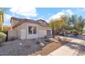 Single-story home with desert landscaping, showcasing its clean design and curb appeal at 17655 W Tasha Dr, Surprise, AZ 85388