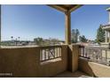 This is a cozy balcony with view of the nearby homes and landscape with an open blue sky above at 18250 N Cave Creek Rd # 164, Phoenix, AZ 85032