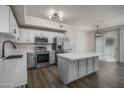 Modern kitchen with stainless steel appliances, a large island, and elegant white cabinets at 18250 N Cave Creek Rd # 164, Phoenix, AZ 85032
