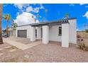 Contemporary home featuring a white exterior, gray accents, desert landscaping and an inviting entry at 1847 W Isleta Ave, Mesa, AZ 85202