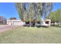 Attractive home with a green lawn and mature trees providing shade at 18622 E Via De Arboles --, Queen Creek, AZ 85142