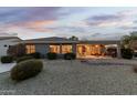 The home's backyard is designed with low-maintenance desert landscaping and a covered patio at 20029 N Coronado Ridge Dr, Surprise, AZ 85387