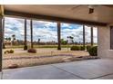 Picturesque view from the covered patio overlooking the lush golf course and mature palm trees at 20029 N Coronado Ridge Dr, Surprise, AZ 85387