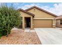 Charming single-story home featuring a low-maintenance front yard and attached two-car garage at 213 S 225Th Ln, Buckeye, AZ 85326