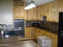 Spacious kitchen with oak cabinets, double ovens, and modern appliances at 2156 W Broadway Ave, Coolidge, AZ 85128