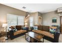 Inviting living room showcasing comfortable seating and natural light through large windows at 23693 W La Vista Cir, Buckeye, AZ 85396