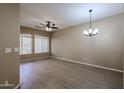 Spacious living room with wood floors, ceiling fan, and modern chandelier at 2600 E Springfield Pl # 59, Chandler, AZ 85286