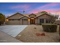 Charming single-story home with a three-car garage and desert landscaping under a vivid sky at 3060 W Ironwood Cir, Chandler, AZ 85226