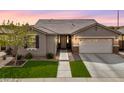 Charming single-story home with desert landscaping, a two-car garage and a stylish, decorative front door at 3121 N Loma Vista Dr, Mesa, AZ 85213