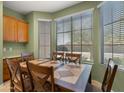 This dining room has three windows, natural light, a wood table, and six chairs at 3708 W Rushmore Dr, Anthem, AZ 85086