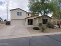 Two-story house featuring stucco exterior, three car garage, desert landscaping, and a curved driveway at 40232 W Marion May Ln, Maricopa, AZ 85138