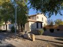 Rear view of the two-story home showing desert landscaping at 40232 W Marion May Ln, Maricopa, AZ 85138