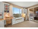 Bright study room with built-in desks, storage, and large windows overlooking the pool at 41006 N Noble Hawk Way, Anthem, AZ 85086