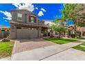 Charming two-story home featuring a two car garage, desert landscaping, and covered front porch with furniture at 4281 E Mesquite St, Gilbert, AZ 85296