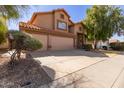 Charming two-story home with a terracotta roof and a spacious three car garage at 4643 E Villa Maria Dr, Phoenix, AZ 85032