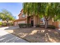 Attractive two-story home featuring a terracotta roof, three car garage, and desert landscaping at 4643 E Villa Maria Dr, Phoenix, AZ 85032